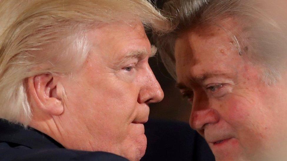 President Donald Trump talks to chief strategist Steve Bannon during a swearing in ceremony for senior staff at the White House in Washington, January 22