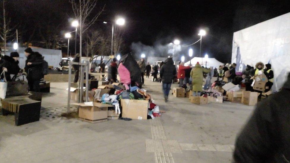 This is the train station in Lviv where Oksana. Crowds of people surround surround piles of belongings