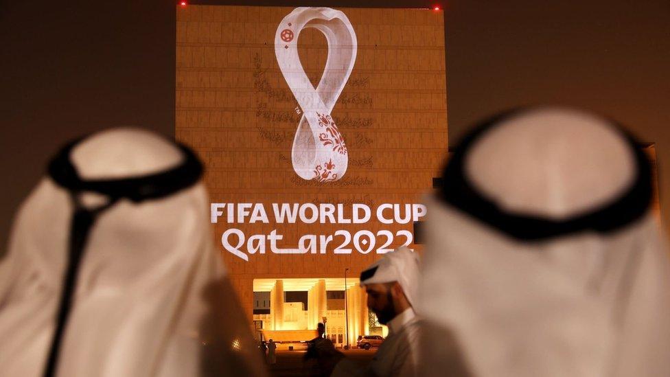 The Qatar World Cup logo projected onto a building