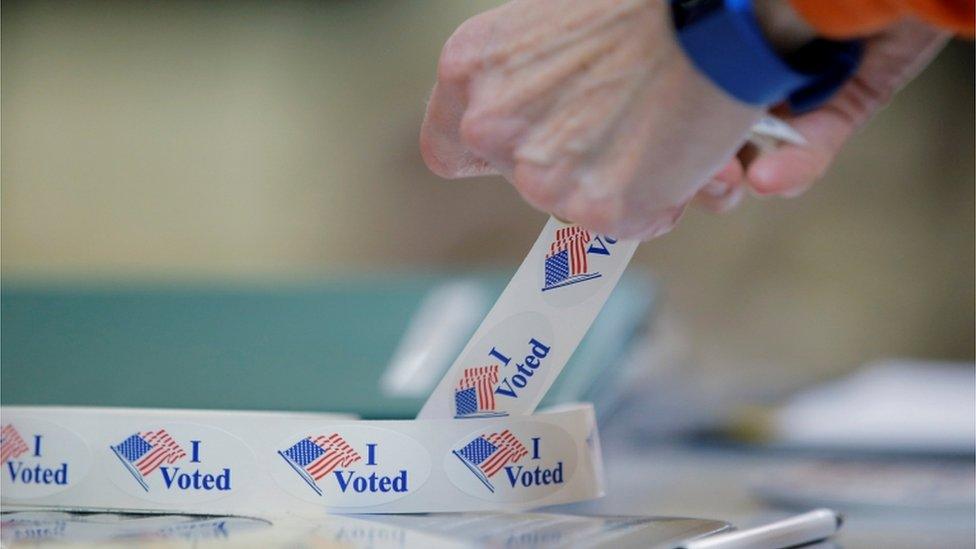 Voter peels off an 'I voted' sticker