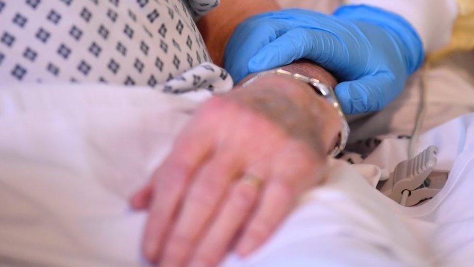 Hands in hospital bed