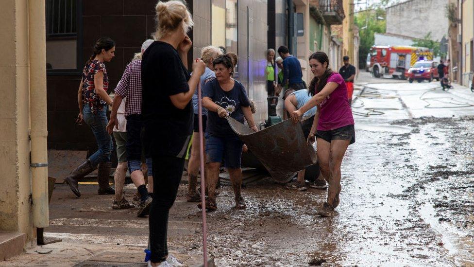 Several neighbours work in the areas affected by the rains, on September 3, 2023, in Santa Barbara, Tarragona, Catalonia, Spain.