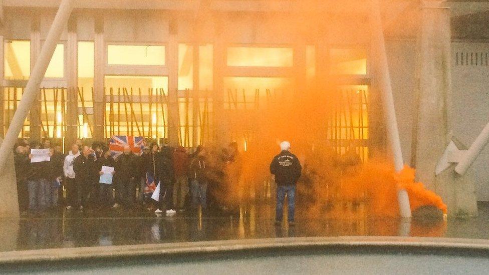 Smoke canister during fishermen's demonstration outside Scottish Parliament