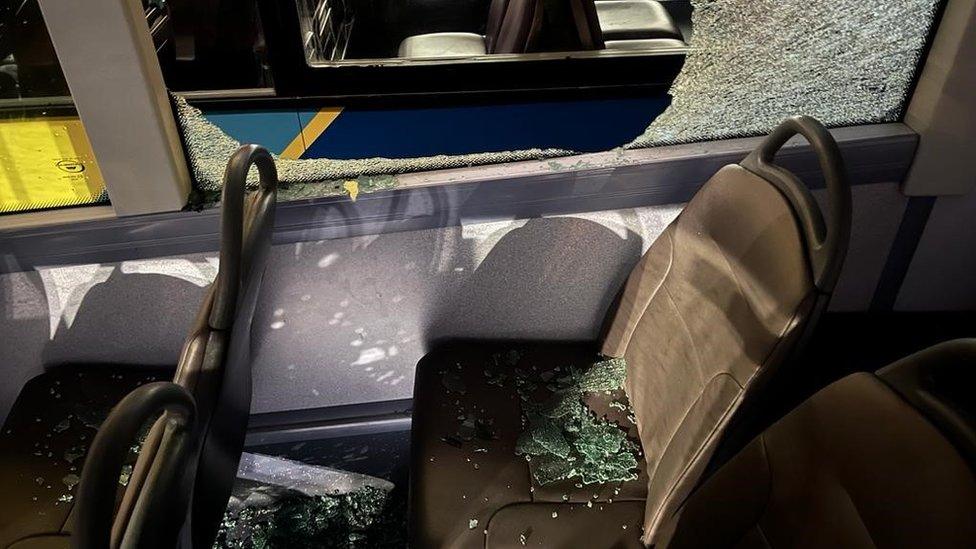 Service 111 bus in Wales with a shattered window