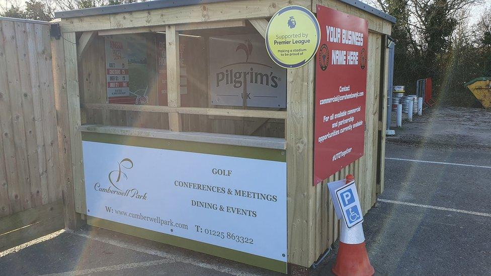 A wooden shed, looking fresh and new, with a big hatch at the front to greet people