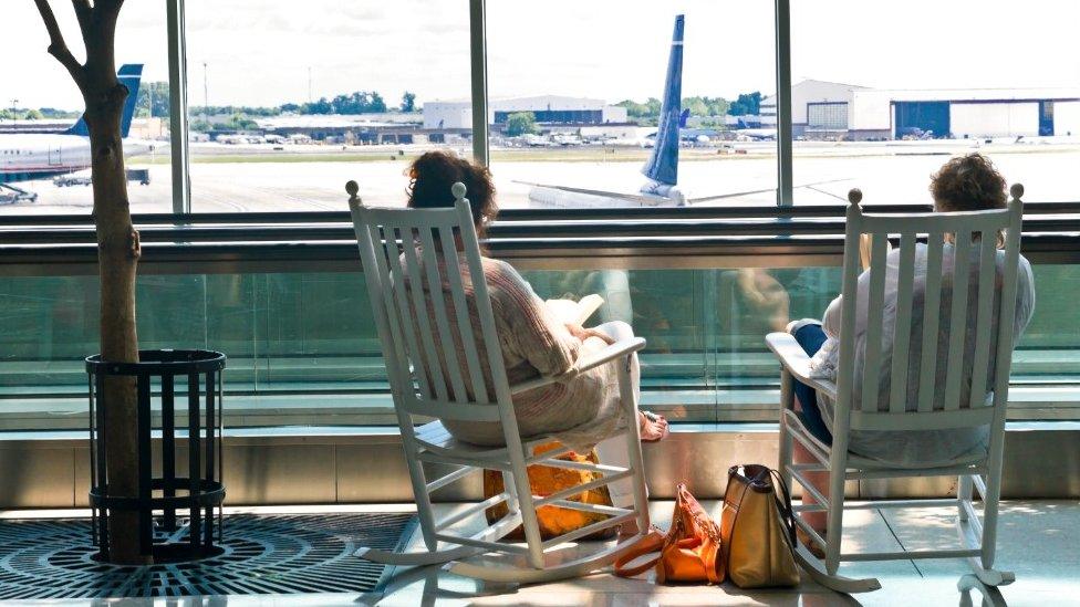 People watching planes at an airport