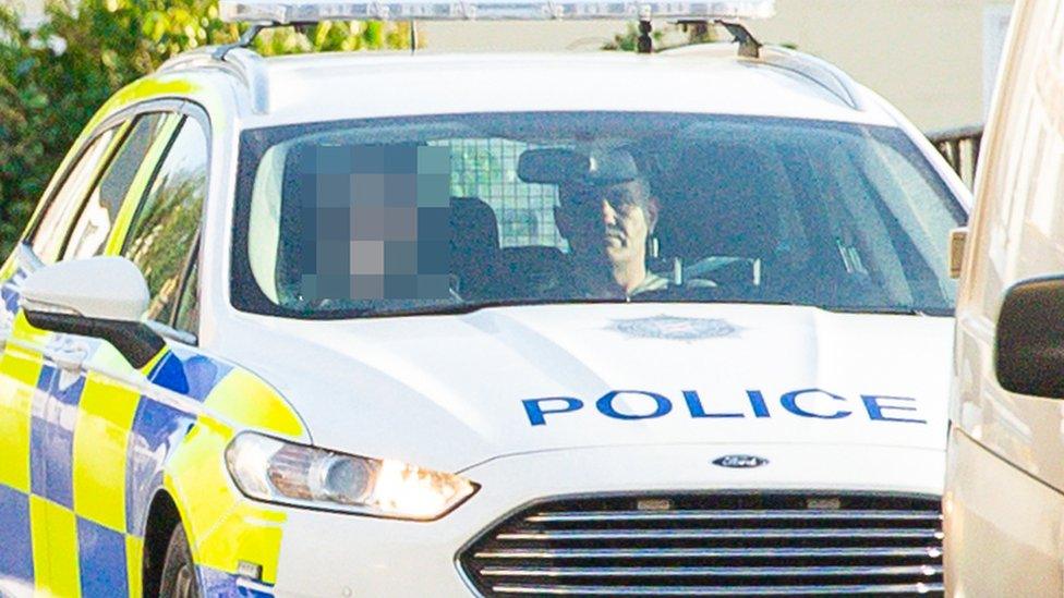 Sean Small in police car