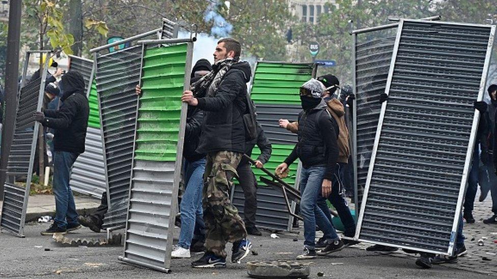 Protesters set up barricades against French riot police on Place d'Italie