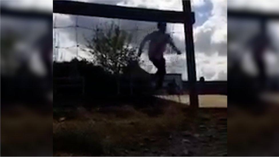 A boy running across the tracks to avoid a train