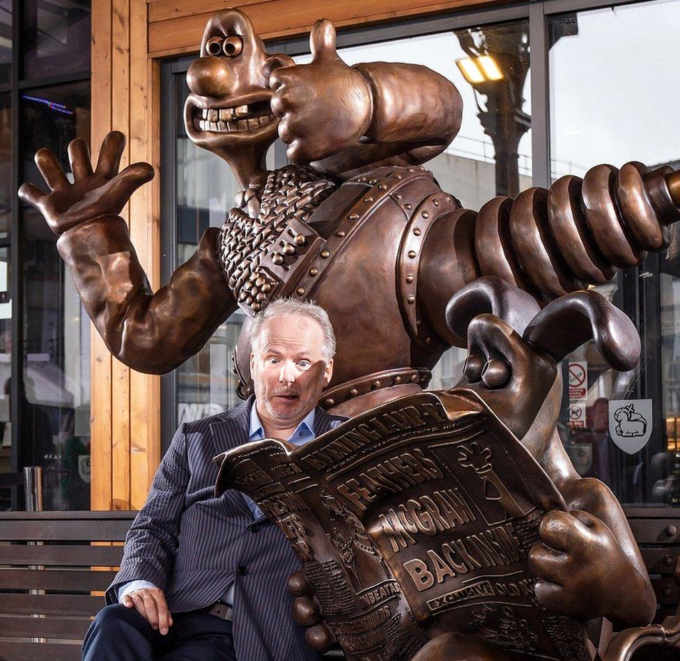 Nick Park strike a funny pose with stature