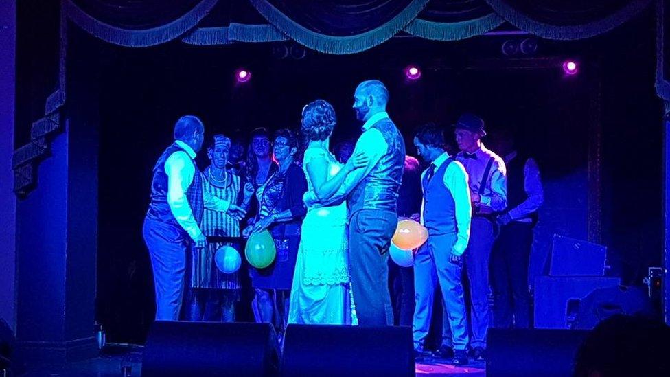 The happy couple dancing on-stage