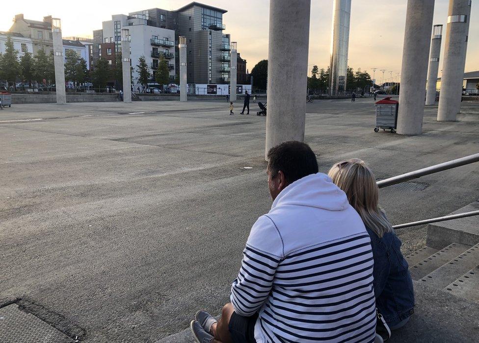 A couple drinking at Cardiff Bay