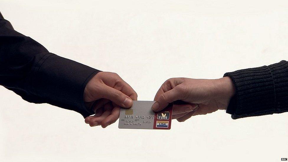 Couple handing over credit card