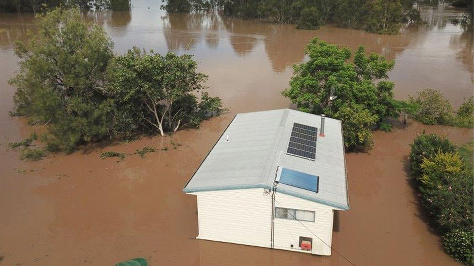 A house is seen surrounded by flood waters from the Mary River in the town of Tiaro, 198 kilometres north of Brisbane.