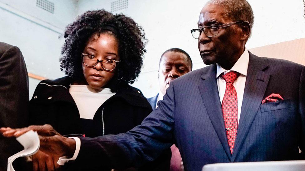 Bona Mugabe (L) helping her father Robert Mugabe to vote in Zimbabwe - Monday 30 July 2018