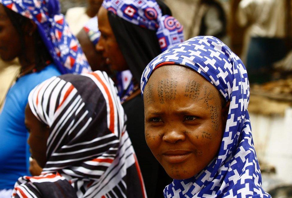 A Sudanese girl poses on Sunday at a local market in a protected region, 480 km from the capital Khartoum.