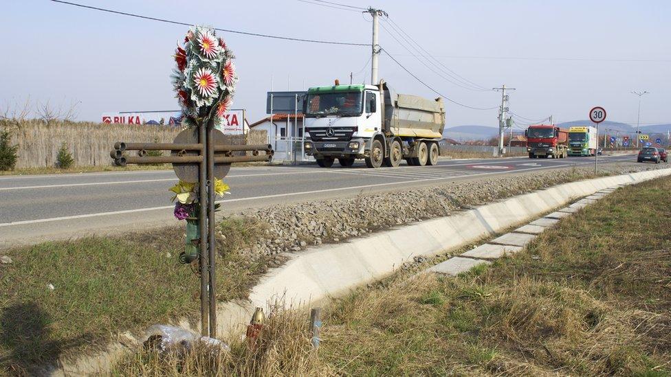 A cross marks a fatal accident on a road in Mures County in Romania