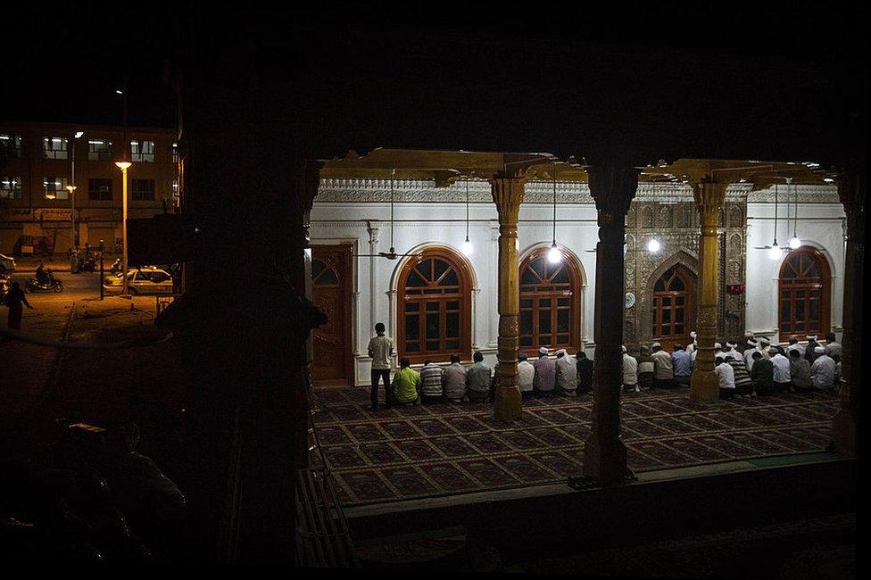 Uyghur men pray at an open air mosque on July 31, 2014 in old Kashgar, Xinjiang Uyghur Autonomous Region, China.