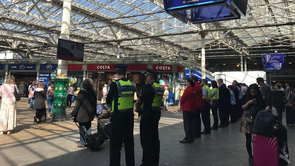 People at Waverley Station in Edinburgh stop for minute's silence