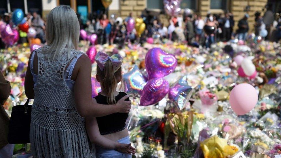 People gather to see flowers and messages of support in St Ann"s Square in Manchester, northwest England on May 25, 2017