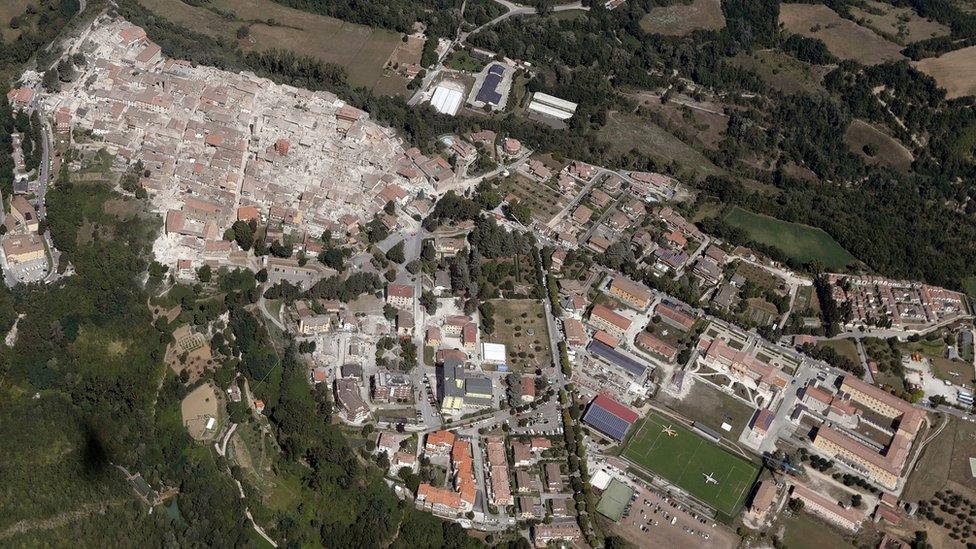 Aerial photo shows damaged buildings in old centre of Amatrice (left) after an earthquake, 24 Aug 16