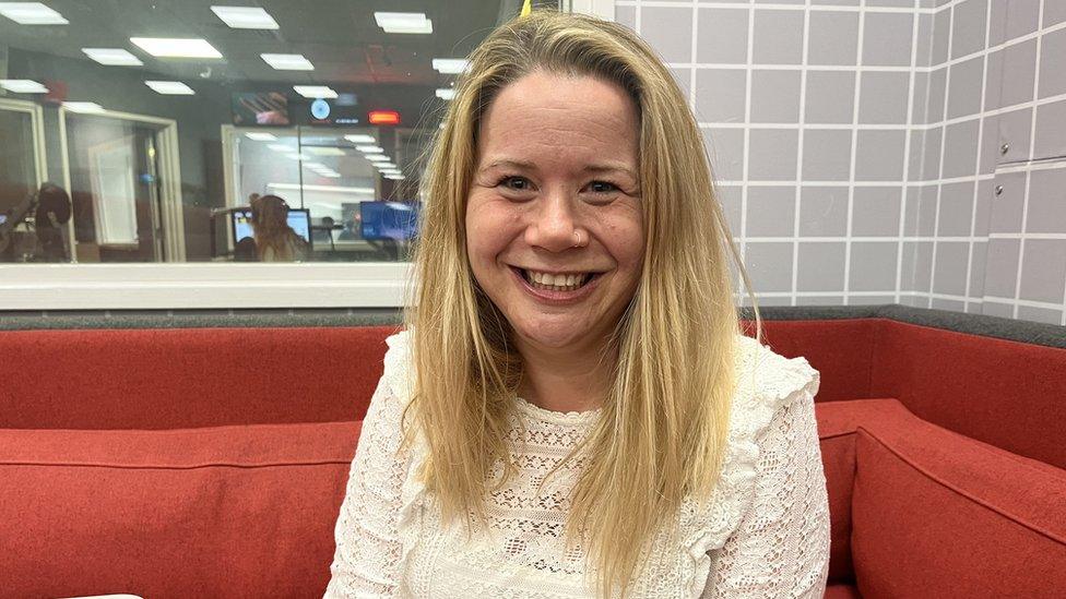 Lucy Stockall from Bristol After Stroke sitting on a red sofa