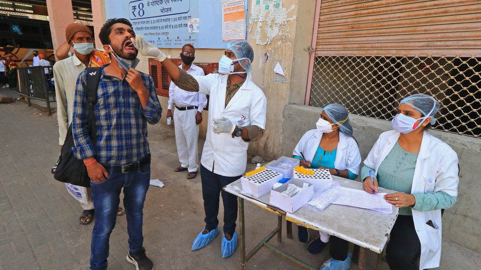 A medic tests a bus passenger in Jaipur, Rajasthan, India, on Thursday