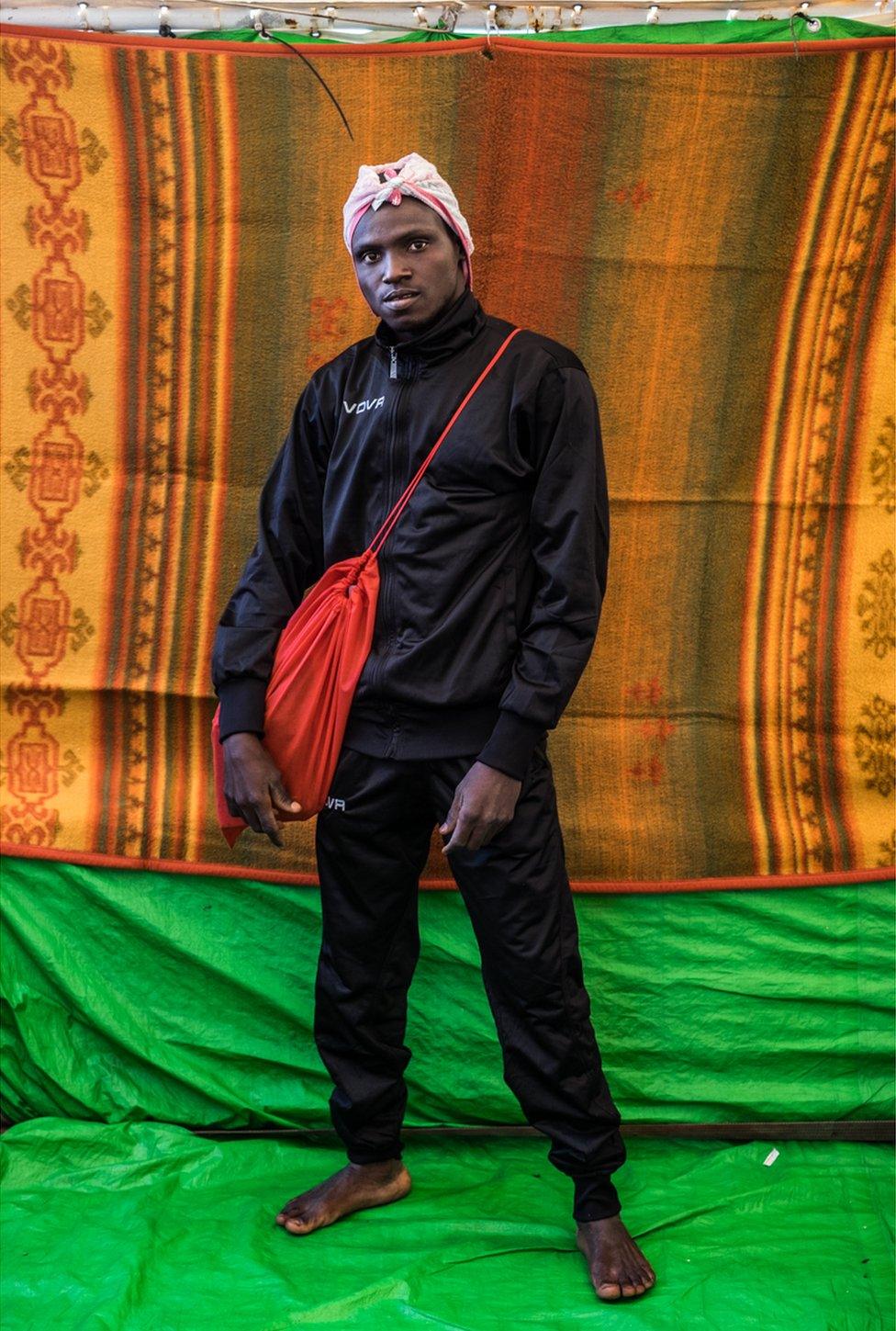 Ahmed Mohammed poses with a red bag across his chest