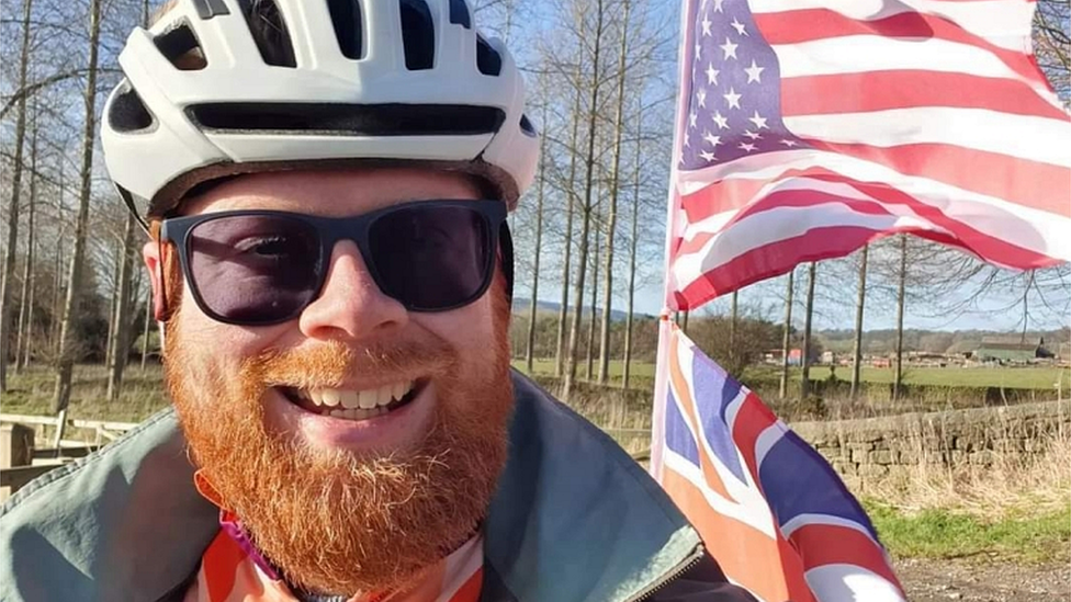 Anthony Butcher next to USA flag