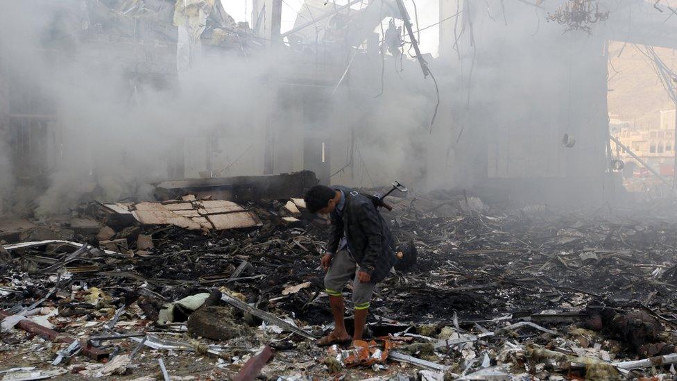 A Yemeni man inspects the rubble of a destroyed building following an air strike on a funeral ceremony in the capital Sanaa, 8 October 2016