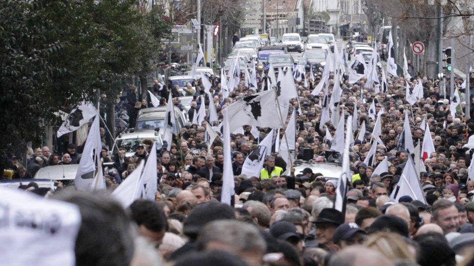 People hold flags during street protests in Ajaccio, Corsica on 3 February 2018.