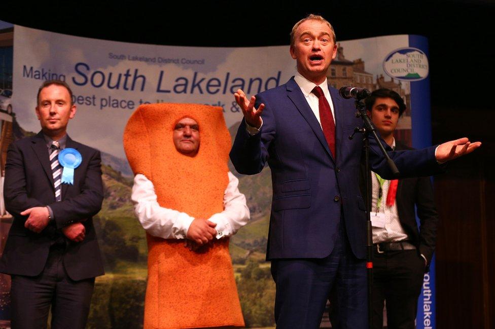 Leader of the Liberal democrats Tim Farron celebrates beating Conservative party candidate James Airey (L) Independent candidate Mr Fishfinger and Labour candidate Eli Aldridge (R) following the announcement of the results at the Westmoorland and Lonsdale constituency count at Kendal Leisure Centre on June 9, 2017 in Kendal,