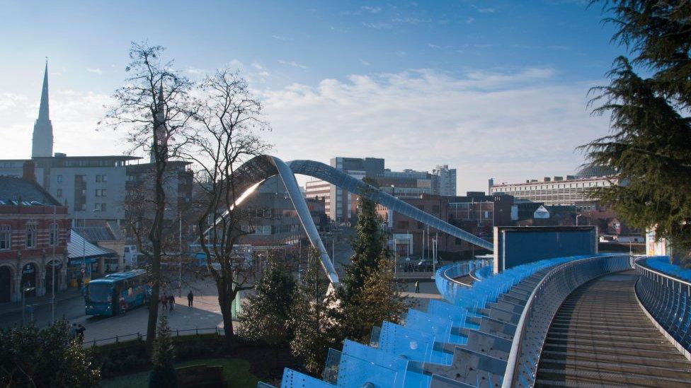 Coventry skyline with Whittle Arch on Millennium square and the Cathedral, seen from the Glass bridge