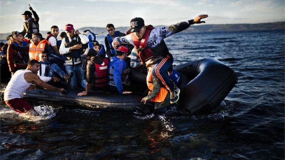 Migrants arriving by boat at Lesvos