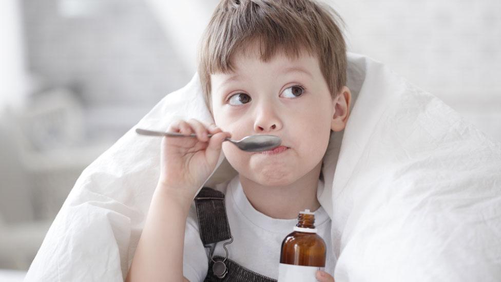 Boy with cough medicine