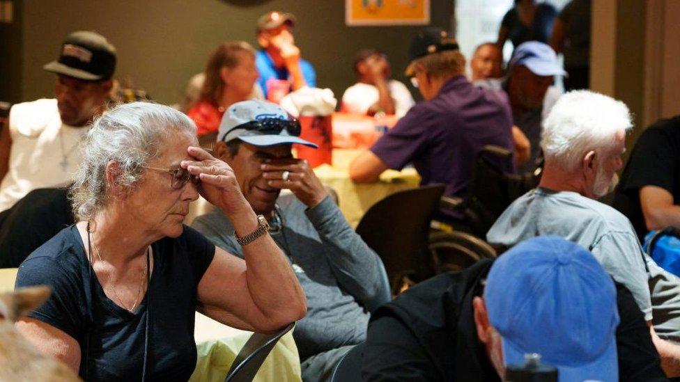 K.C. Griffin sits in a crowded room at Justa Center, one of the Valley's many cooling centers, during a heat wave in Phoenix, Arizona,