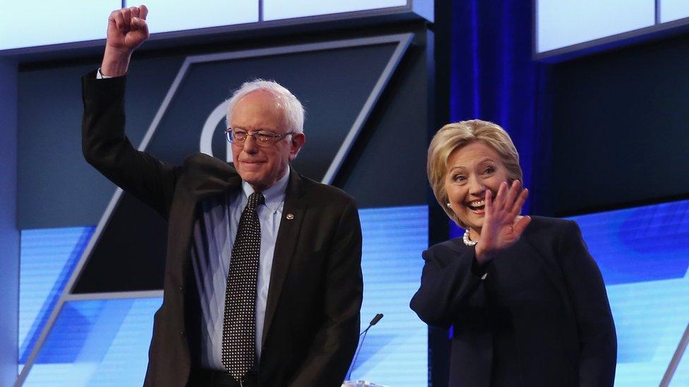 Bernie Sanders and Hillary Clinton wave to the audience after their debate in Miami.