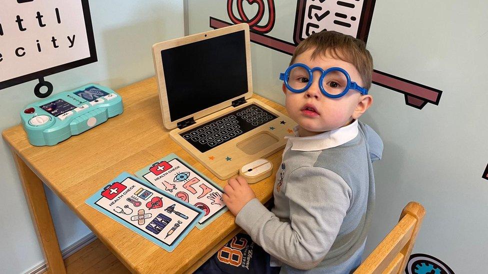 Four year old Teddy with a toy computer