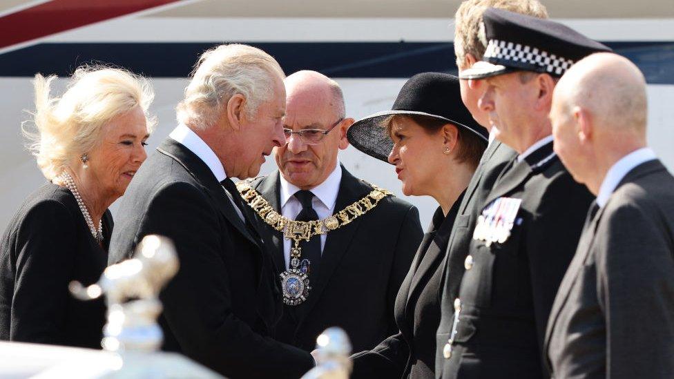 King Charles III shakes hands with Scotland's First Minister Nicola Sturgeon