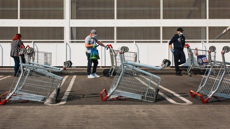 People queue outside supermarket