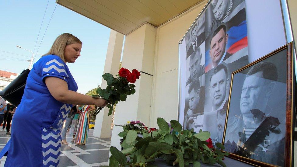 A woman places flowers to commemorate the leader of the separatist self-proclaimed Donetsk People's Republic Alexander Zakharchenko, 1 September 2018