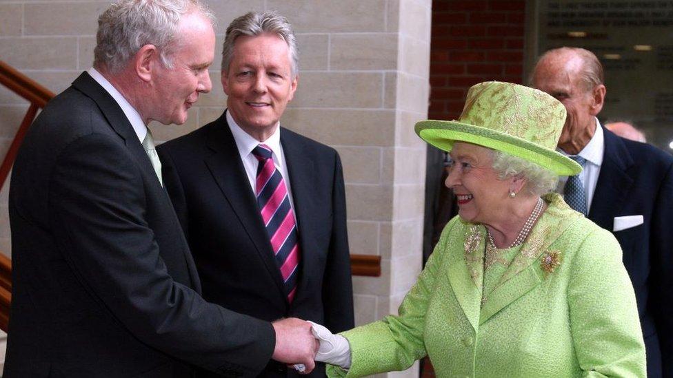 File photo dated 27/6/2012 of Queen Elizabeth II shaking hands with Northern Ireland Deputy First Minister Martin McGuinness watched by First minister Peter Robinson (centre) at the Lyric Theatre in Belfast.