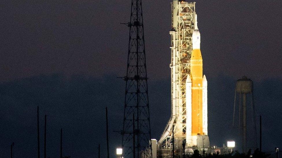 A handout photo made available by NASA shows NASA's Space Launch System (SLS) rocket with the Orion spacecraft aboard