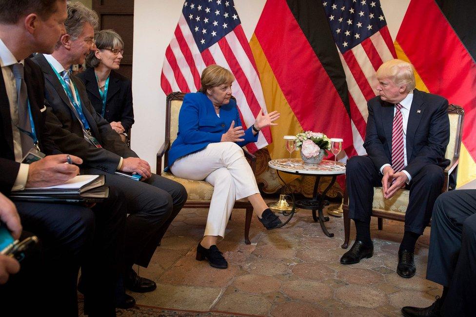 German Chancellor Angela Merkel and US President Donald Trump talk in Taormina, Sicily, 26 May