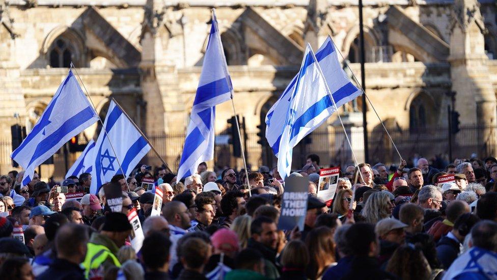 People at a vigil at Parliament Square in London, for victims and hostages of the Hamas attacks.