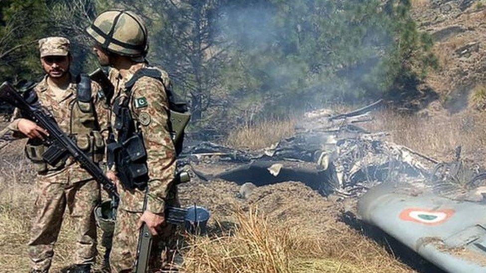 Pakistan soldiers by what Pakistan says is a downed Indian jet