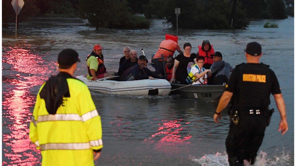 People have had to use boats and inflatable beach toys to escape the water.