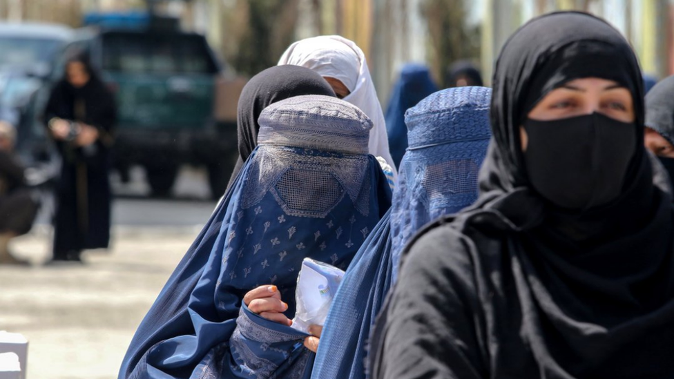 Afghans line up to receive ration aid distributed by Gulbahar Foundation to 1,000 needy and poor families ahead of Ramadan, in Kabul, Afghanistan, 18 March 2023.