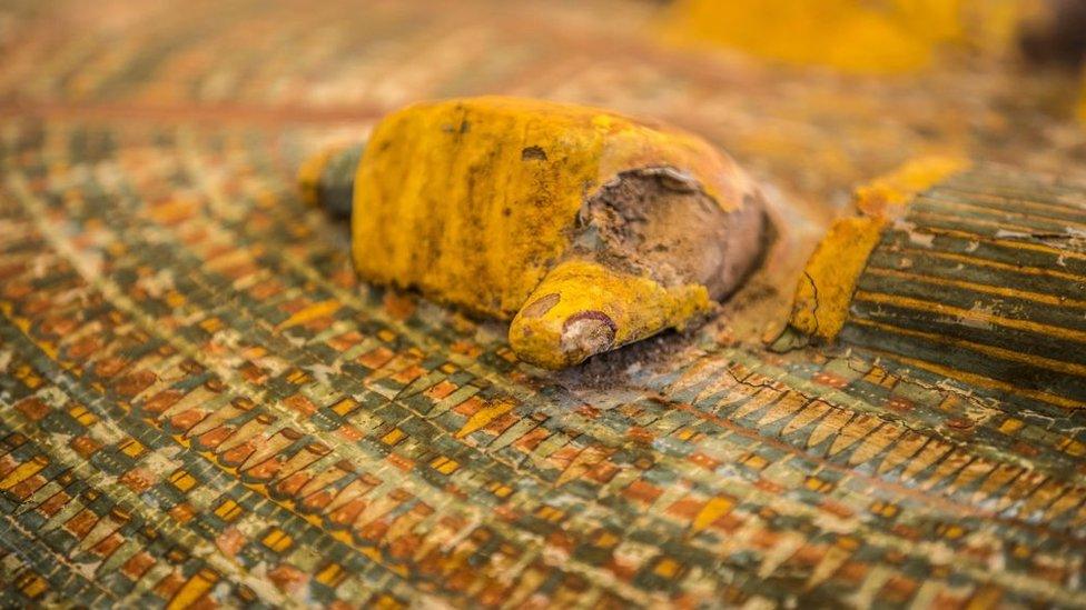 A-close-up-of-a-wooden-hand-on-a-sarcophagus