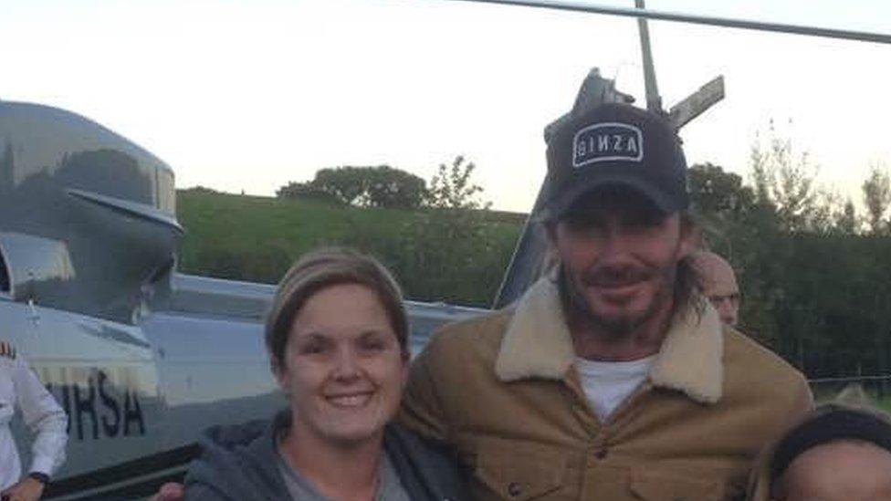 David Beckham and his helicopter, posing with a fan